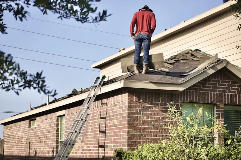 Professional roofer working on a residential roof in Trude